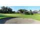 Golf course view with sand trap, lush greens, and homes in background at 770 Egret Walk Ln, Venice, FL 34292
