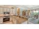 Kitchen features granite island, stainless steel appliances, and view to living room at 770 Egret Walk Ln, Venice, FL 34292