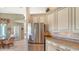 Kitchen features stainless steel refrigerator and granite countertops at 770 Egret Walk Ln, Venice, FL 34292