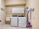 Laundry room with washer, dryer, and cabinets at 770 Egret Walk Ln, Venice, FL 34292