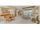 Living room with seating area, featuring a glass sliding door to the pool area at 770 Egret Walk Ln, Venice, FL 34292