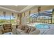 Spacious living area with serene pool and landscape views at 770 Egret Walk Ln, Venice, FL 34292