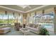 Living room with pool view and comfortable seating at 770 Egret Walk Ln, Venice, FL 34292