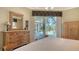 Main bedroom with wood furniture and sliding doors to pool area at 770 Egret Walk Ln, Venice, FL 34292