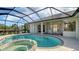 Large screened pool and spa with view of backyard at 770 Egret Walk Ln, Venice, FL 34292