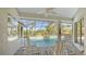 Covered patio with seating area overlooking the pool and lush greenery at 770 Egret Walk Ln, Venice, FL 34292