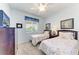 Twin bedroom with two beds, dresser, and window at 8105 Grand Estuary Trl # 403, Bradenton, FL 34212