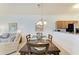 Condo dining room with wood table and chandelier at 8105 Grand Estuary Trl # 403, Bradenton, FL 34212