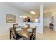 Bright dining room with a wooden table and seating for four at 8105 Grand Estuary Trl # 403, Bradenton, FL 34212