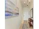 Bright condo entry with wood console table and art at 8105 Grand Estuary Trl # 403, Bradenton, FL 34212