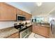 Modern kitchen with stainless steel appliances and granite countertops at 8105 Grand Estuary Trl # 403, Bradenton, FL 34212