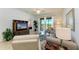 Living room with comfy seating and view to balcony at 8105 Grand Estuary Trl # 403, Bradenton, FL 34212