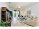 Living room with sofa, chairs, and access to balcony at 8105 Grand Estuary Trl # 403, Bradenton, FL 34212