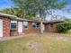 Brick home with front yard and driveway at 102 N Mars Ave, Clearwater, FL 33755