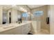 Double vanity bathroom with large shower and modern finishes at 10269 Canaveral Cir, Sarasota, FL 34241