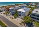 Aerial view showcasing a modern house's location near the beach and other houses at 106 9Th S St, Bradenton Beach, FL 34217