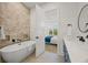 Bathroom with soaking tub and double vanity at 106 9Th S St, Bradenton Beach, FL 34217