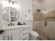 Modern bathroom with walk-in shower and white vanity at 106 9Th S St, Bradenton Beach, FL 34217
