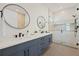 Modern bathroom with dual vanities, a large shower, and blue cabinets at 106 9Th S St, Bradenton Beach, FL 34217
