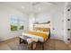 Bedroom with king bed and wood accent wall at 106 9Th S St, Bradenton Beach, FL 34217