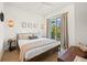 Cozy bedroom with a wooden bed frame and access to a balcony at 106 9Th S St, Bradenton Beach, FL 34217