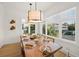 Bright dining room with a large wood table and bay windows at 106 9Th S St, Bradenton Beach, FL 34217