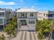 Two-story house featuring a modern design, two-car garage, and a metal roof at 106 9Th S St, Bradenton Beach, FL 34217