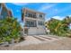 Two-story house with double garage and tropical landscaping at 106 9Th S St, Bradenton Beach, FL 34217