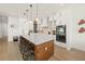 Modern kitchen with island, stainless steel appliances, and white cabinetry at 106 9Th S St, Bradenton Beach, FL 34217