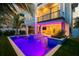 Expansive pool with built-in water features, night lighting, and a spacious patio at 106 9Th S St, Bradenton Beach, FL 34217