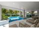 Inviting pool area with lounge chairs, covered patio, and outdoor dining at 106 9Th S St, Bradenton Beach, FL 34217