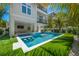 Modern rectangular pool with swim-up bar and lush landscaping at 106 9Th S St, Bradenton Beach, FL 34217