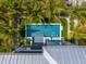 Elevated view of a rectangular swimming pool with a spa, surrounded by lush landscaping at 106 9Th S St, Bradenton Beach, FL 34217