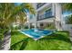 Expansive pool and patio area with tropical landscaping at 106 9Th S St, Bradenton Beach, FL 34217