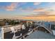 Rooftop deck with white chairs and ocean view, perfect for sunset relaxation at 106 9Th S St, Bradenton Beach, FL 34217