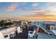 Rooftop deck with white chairs and ocean view, perfect for sunset relaxation at 106 9Th S St, Bradenton Beach, FL 34217