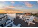 Rooftop deck with white chairs and a panoramic ocean view at 106 9Th S St, Bradenton Beach, FL 34217
