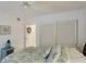 Bedroom with sliding door closet and a bed with pillows at 1109 Edgewater Cir # 1109, Bradenton, FL 34209