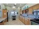 Community kitchen featuring wood cabinets and tiled floors at 1109 Edgewater Cir # 1109, Bradenton, FL 34209