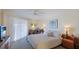 Main bedroom with a king-size bed and sliding door access to balcony at 1109 Edgewater Cir # 1109, Bradenton, FL 34209