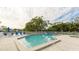 Community pool with a hot tub and surrounding lush landscaping at 1109 Edgewater Cir # 1109, Bradenton, FL 34209