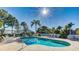 Relaxing kidney-shaped pool with patio and lounge chairs at 1109 Edgewater Cir # 1109, Bradenton, FL 34209