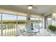 Spacious sunroom with table and chairs and water views at 1109 Edgewater Cir # 1109, Bradenton, FL 34209