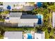 Aerial view showing house, pool, lush landscaping, and neighboring homes at 112 Mangrove Ave, Anna Maria, FL 34216