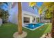 Backyard oasis with pool, putting green, and outdoor shower at 112 Mangrove Ave, Anna Maria, FL 34216