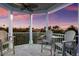 Spacious balcony with multiple chairs and beautiful sunset views at 112 Mangrove Ave, Anna Maria, FL 34216