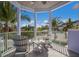 Covered balcony showcasing relaxing patio furniture and ocean view at 112 Mangrove Ave, Anna Maria, FL 34216