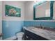 Charming bathroom with blue vanity and marble countertop at 112 Mangrove Ave, Anna Maria, FL 34216