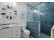 Stylish bathroom featuring marble vanity and blue tile shower at 112 Mangrove Ave, Anna Maria, FL 34216
