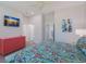 Bedroom with large TV and coastal decor at 112 Mangrove Ave, Anna Maria, FL 34216